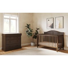 a baby crib and dresser in a room