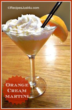 an orange cream martini is garnished with whipped cream