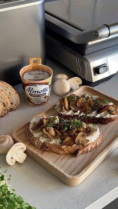 a wooden cutting board topped with sliced mushrooms