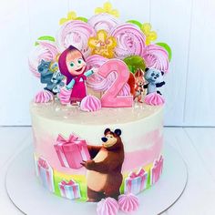 a birthday cake decorated with cartoon characters and decorations