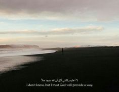 a man standing on top of a beach next to the ocean under a cloudy sky