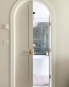 an open door leading to a white room