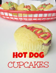 hot dog cupcakes in a red basket with the words hot dog on it