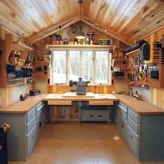 a kitchen with lots of wooden cabinets and counter top space in the middle of it