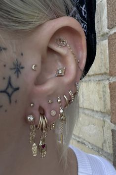 a woman with ear piercings and jewelry on her face