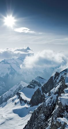 the sun shines brightly over snowy mountains