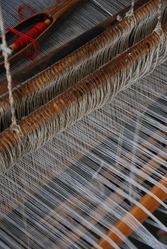 an old weaving machine with yarn on it