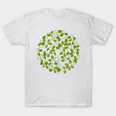 a white t - shirt with green leaves and berries in the shape of a circle