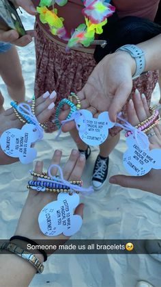 several people holding hands with tags attached to their wristbands that say someone made us all bracelets