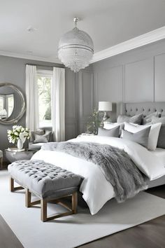 a bedroom with gray walls, white bedding and a bench in front of the bed