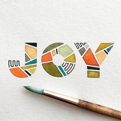 the word joy is made up of different colored shapes and letters with a paintbrush next to it