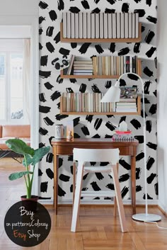 black and white wallpaper with bookshelves in the corner next to a desk