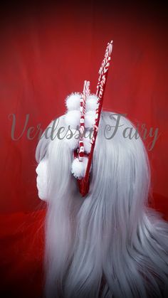 a white wig with candy canes on it's head and the words merry written in red