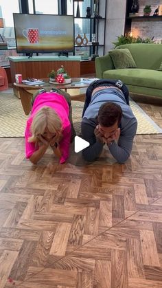 a man and woman doing push ups on the floor