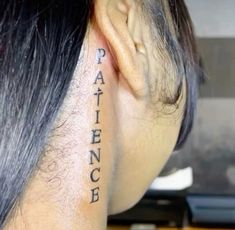 the back of a woman's head has a tattoo on it that reads paince