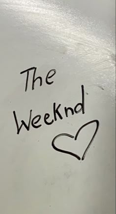 the word the weekend written in black ink on a white surface with a heart drawn on it