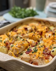 a casserole dish with chicken, potatoes and bacon