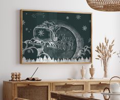 a chalkboard with santa's sleigh drawn on it hangs above a dining room table