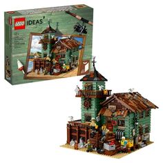 two legos are shown in front of a green house with an advertisement on it