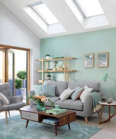 a living room filled with furniture and a skylight