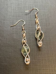 the earrings are made with wire and glass beads