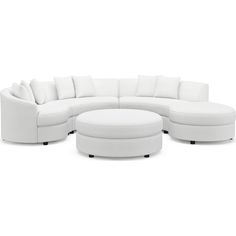 a large white sectional couch and ottoman