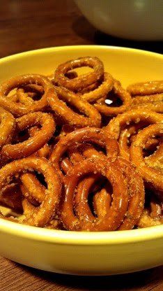 a yellow bowl filled with onion rings on top of a wooden table