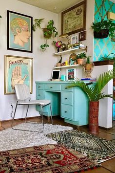 a room with various pictures on the wall and rugs in front of a desk