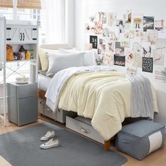 a bedroom with white walls and lots of pictures on the wall, including a bed