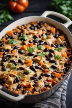 a casserole dish filled with black beans and chicken