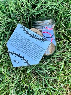 a mason jar with a poem on it sitting in the grass