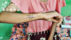 a woman with a tattoo on her arm holding onto another woman's arm and the word, artful written in cursive writing