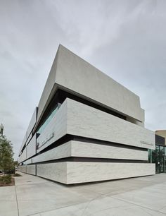 the building is made out of concrete and has two levels on each level that are connected to one another