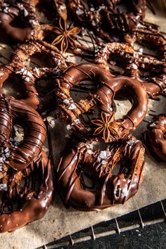 chocolate covered pretzels are sitting on a cooling rack