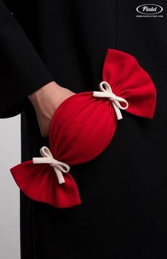 a person wearing a red bow tie around their waist