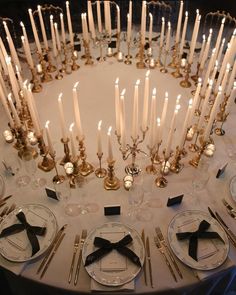 the table is set with candles and place settings for an elegant dinner or special event