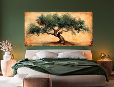 an olive tree painting hanging on the wall above a bed in a room with green walls