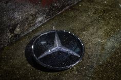 a mercedes emblem is shown on the ground