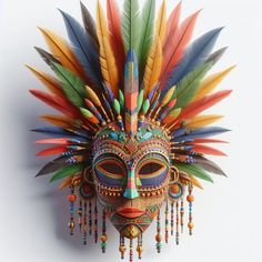 a colorful mask with feathers hanging from it's side on a white wall background