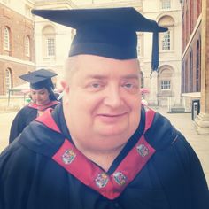 a man wearing a graduation cap and gown