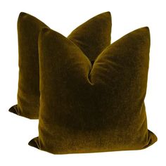 two brown velvet pillows sitting on top of each other