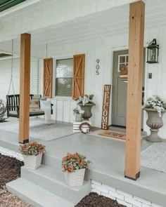 the front porch is clean and ready for us to use as an outdoor space with potted plants