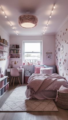 a bedroom with pink walls and lots of decorations on the ceiling, along with a large window