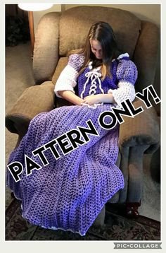 a woman sitting in a chair wearing a purple knitted blanket