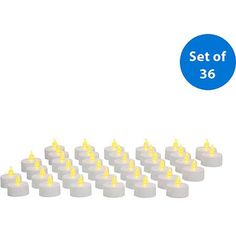 a set of 32 white candles with yellow lights on each candle and the number 26