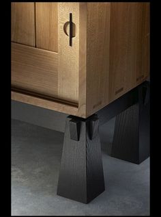 a close up of a wooden cabinet with metal handles on it's doors and drawers