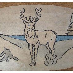 a rug with an image of a deer in the middle and mountains on it's side