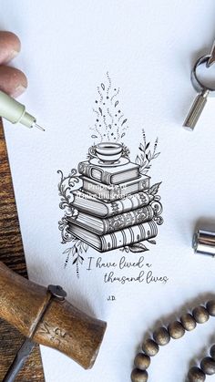 a drawing of a stack of books on top of a paper next to some keys