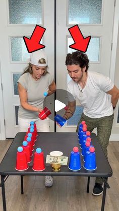 a man and woman standing in front of a table full of cups with blue and red lids