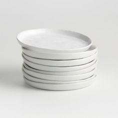 a stack of white plates sitting on top of each other